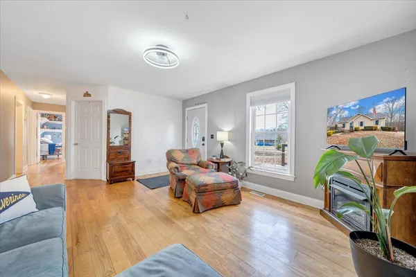 a living room with furniture and a wooden floor