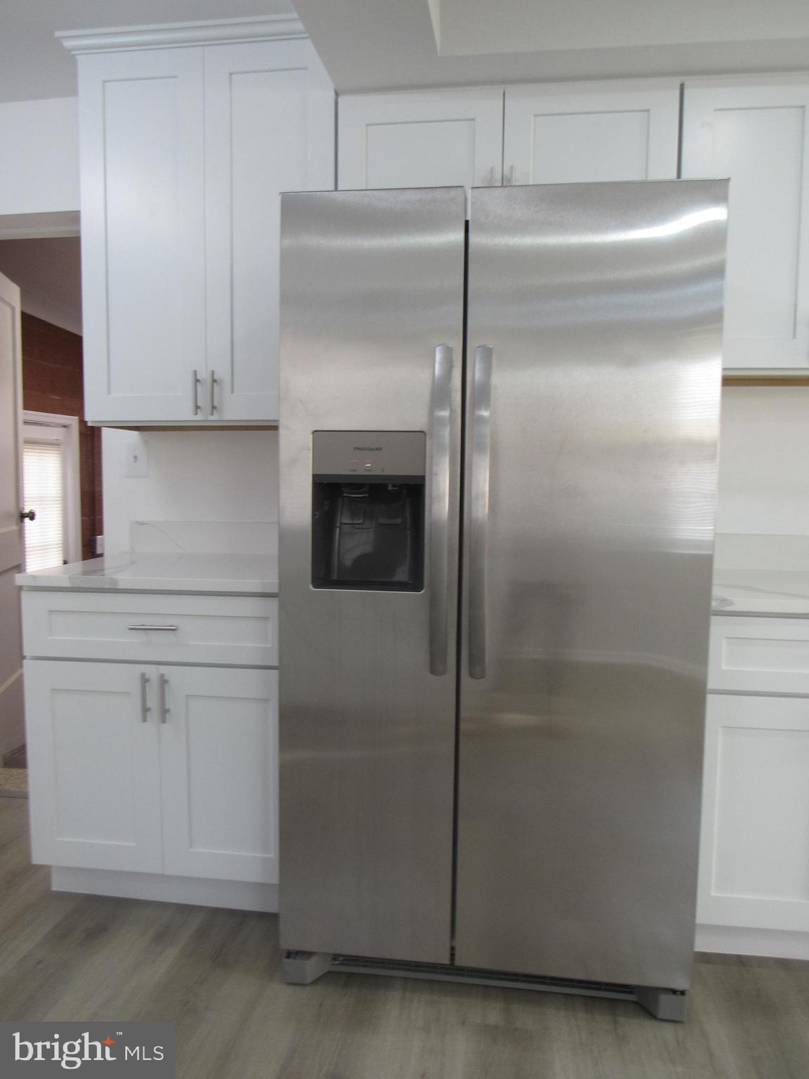 3515 Springdale Avenue District Heights, MD 20747 - Photo 8 of 16 a kitchen with cabinets and a refrigerator