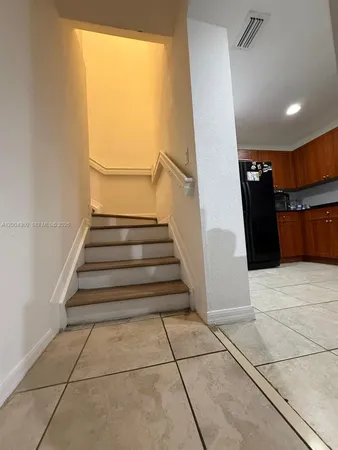 a view of entryway with stairs and wooden floor