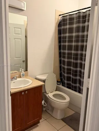 a bathroom with a toilet a sink and shower