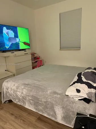 a bedroom with a bed and mirror