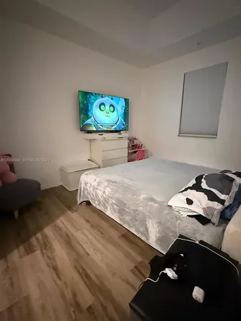 a bedroom with a bed and dresser