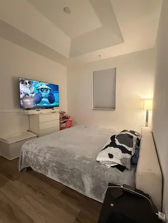 a bedroom with a bed and dresser