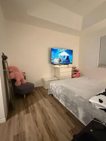 a bedroom with a bed and ceiling fan