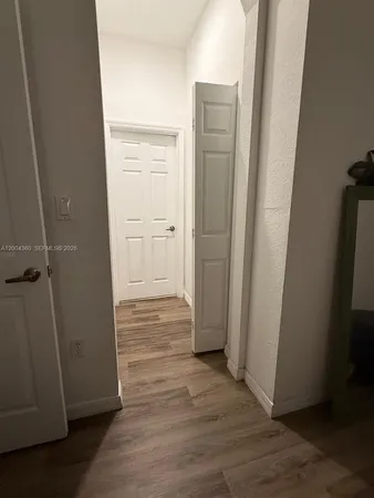 an empty room with wooden floor and closet