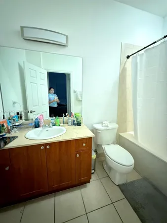 a bathroom with a sink toilet and mirror