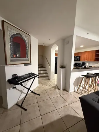 a living room with furniture a flat screen tv and outdoor space
