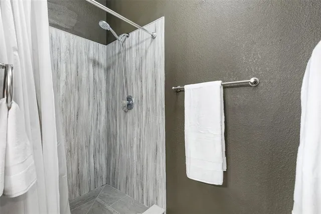 a bathroom with a shower and a curtain