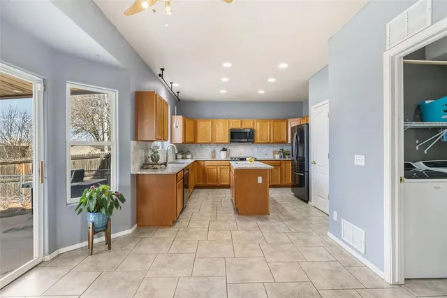 a large space with a large window and a potted plant