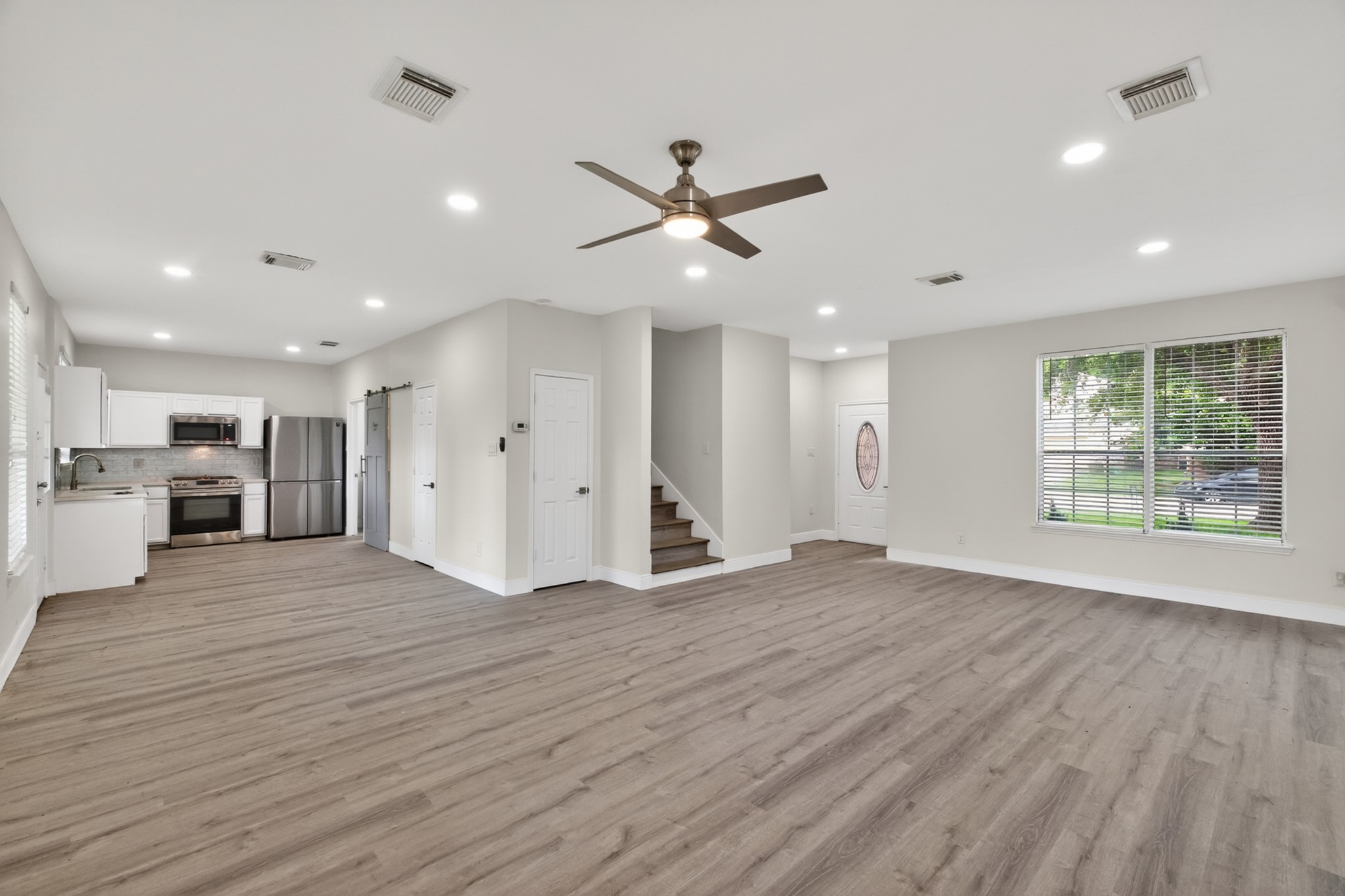 918 Ivycroft Lane Spring, TX 77373 - Photo 7 of 33 a view of an empty room with wooden floor and a window