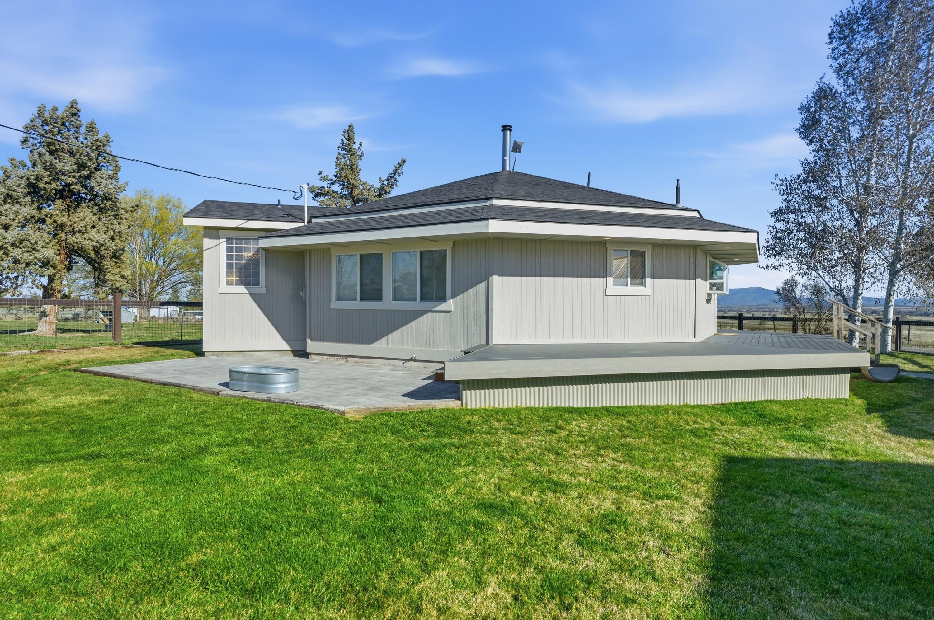 4074 Southwest Reif Road Powell Butte, OR 97753 - Photo 42 of 59 a front view of a house with a yard