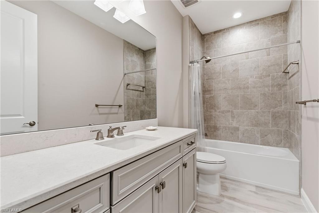 2118 Marquesa Circle Naples, FL 34112 - Photo 11 of 50 a bathroom with a sink a toilet and shower