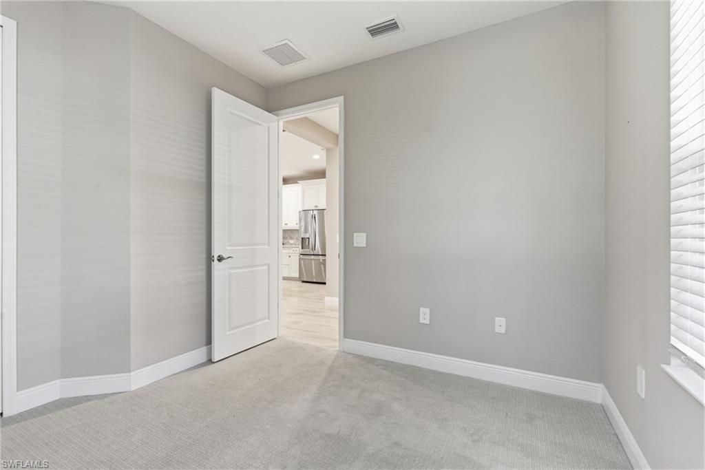 2118 Marquesa Circle Naples, FL 34112 - Photo 20 of 50 an empty room with windows and closet