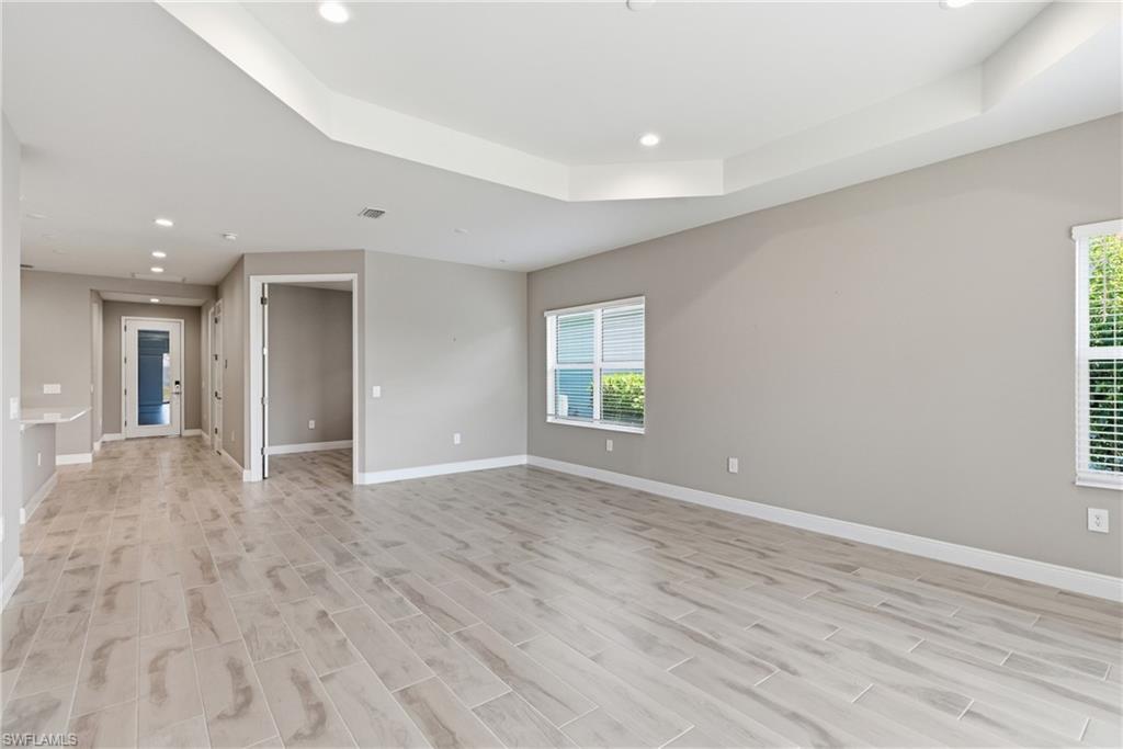 2118 Marquesa Circle Naples, FL 34112 - Photo 24 of 50 wooden floor in an empty room with a window