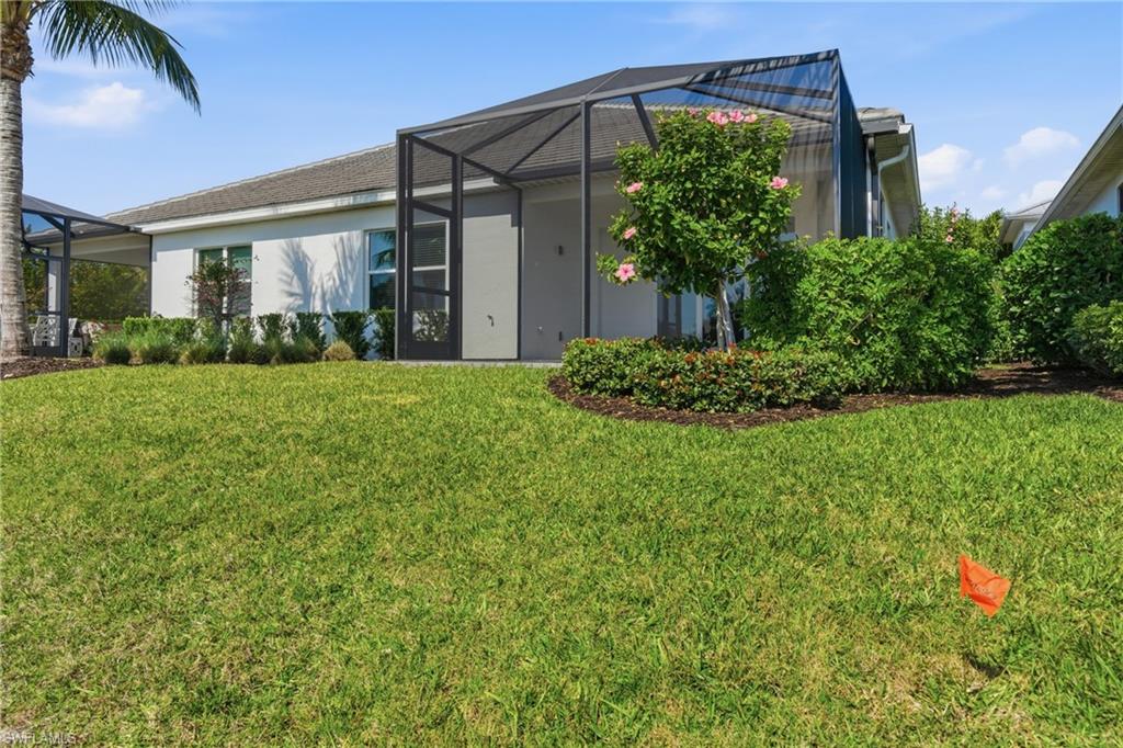 2118 Marquesa Circle Naples, FL 34112 - Photo 29 of 50 front view of house with a yard
