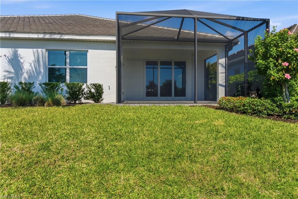 2118 Marquesa Circle Naples, FL 34112 - Photo 30 of 50 a view of a porch with a yard and potted plants
