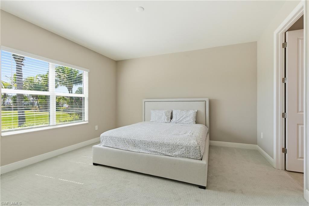 2118 Marquesa Circle Naples, FL 34112 - Photo 32 of 50 a bedroom with a bed and a window with outer view