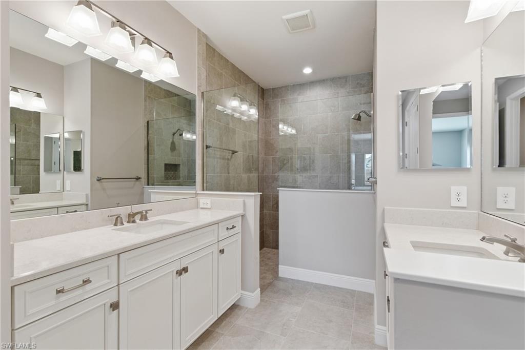 2118 Marquesa Circle Naples, FL 34112 - Photo 34 of 50 a bathroom with a sink double vanity granite tub shower and a mirror
