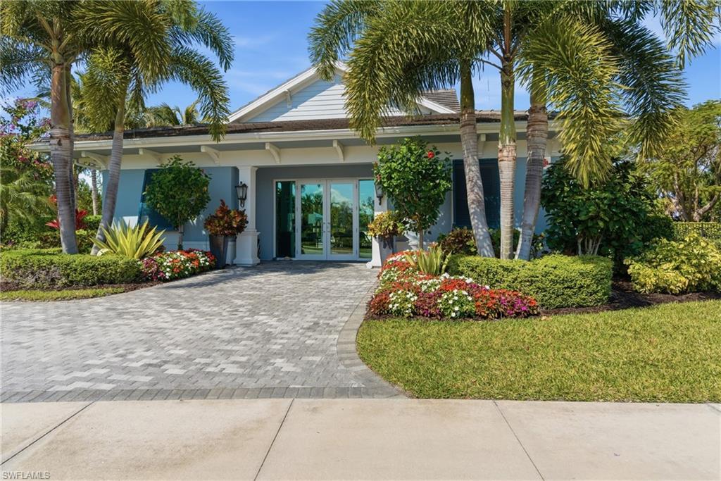 2118 Marquesa Circle Naples, FL 34112 - Photo 42 of 50 front view of a house with a yard
