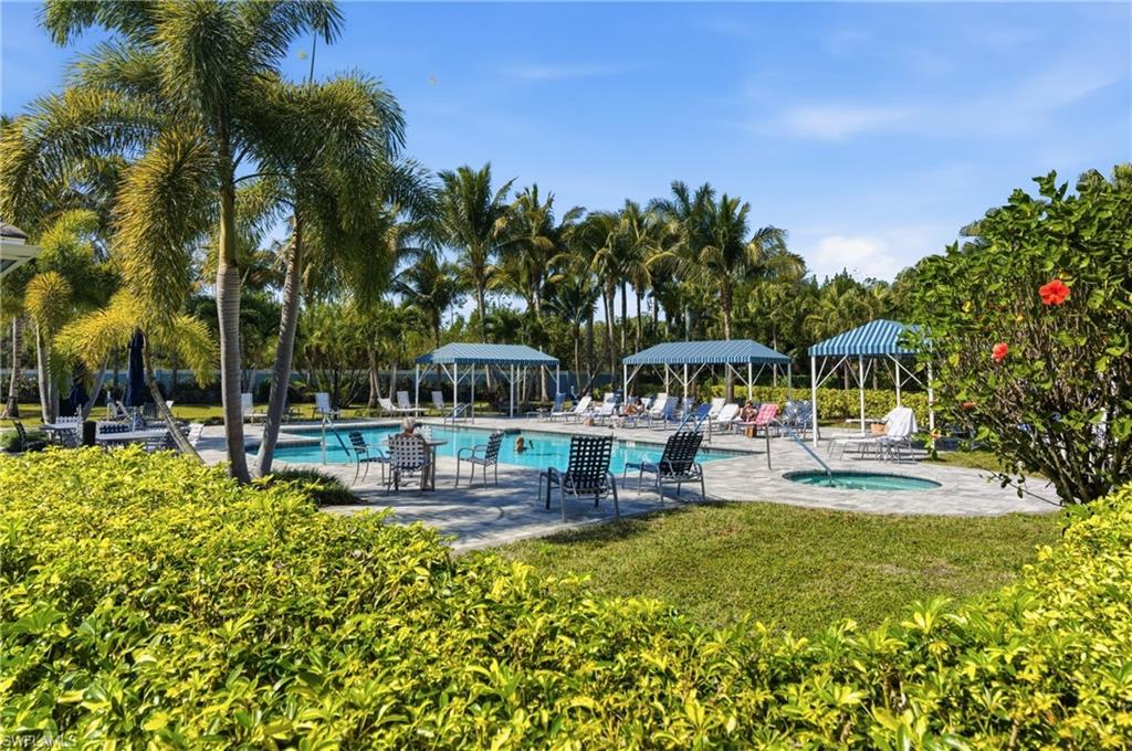 2118 Marquesa Circle Naples, FL 34112 - Photo 44 of 50 a view of a swimming pool with a table and chairs