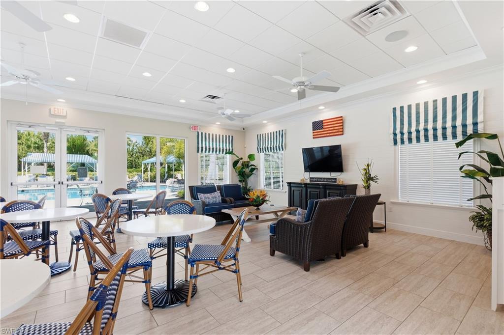 2118 Marquesa Circle Naples, FL 34112 - Photo 48 of 50 a living room with furniture a flat screen tv and a fireplace