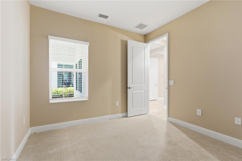 2118 Marquesa Circle Naples, FL 34112 - Photo 9 of 50 a view of an empty room with a window