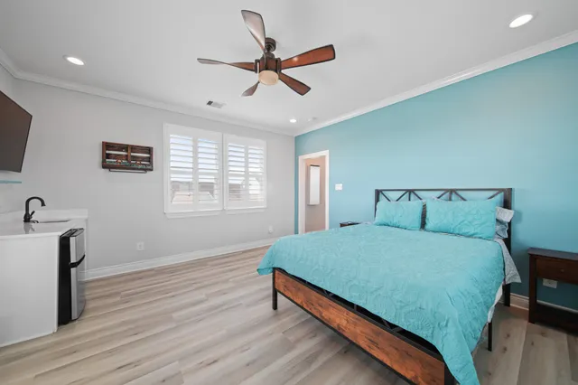 a bedroom with a bed and a ceiling fan