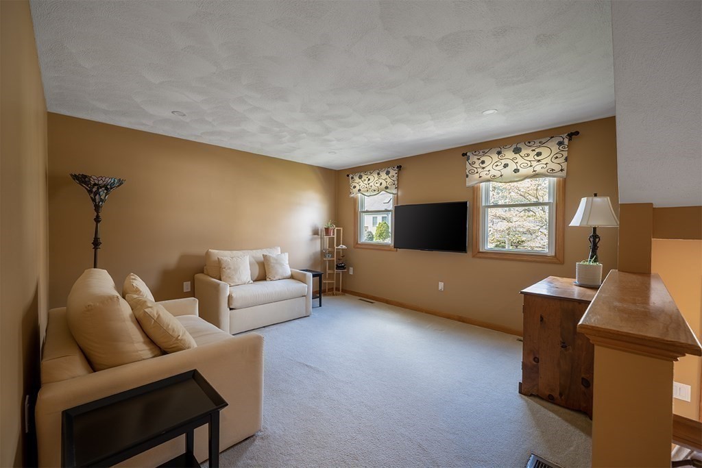 21 Swan Lane Billerica, MA 01821 - Photo 15 of 41 a living room with furniture and a flat screen tv
