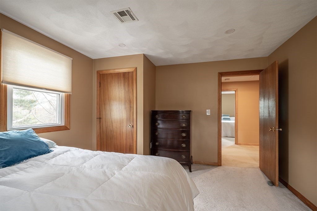 21 Swan Lane Billerica, MA 01821 - Photo 25 of 41 a bedroom with a bed and a dresser