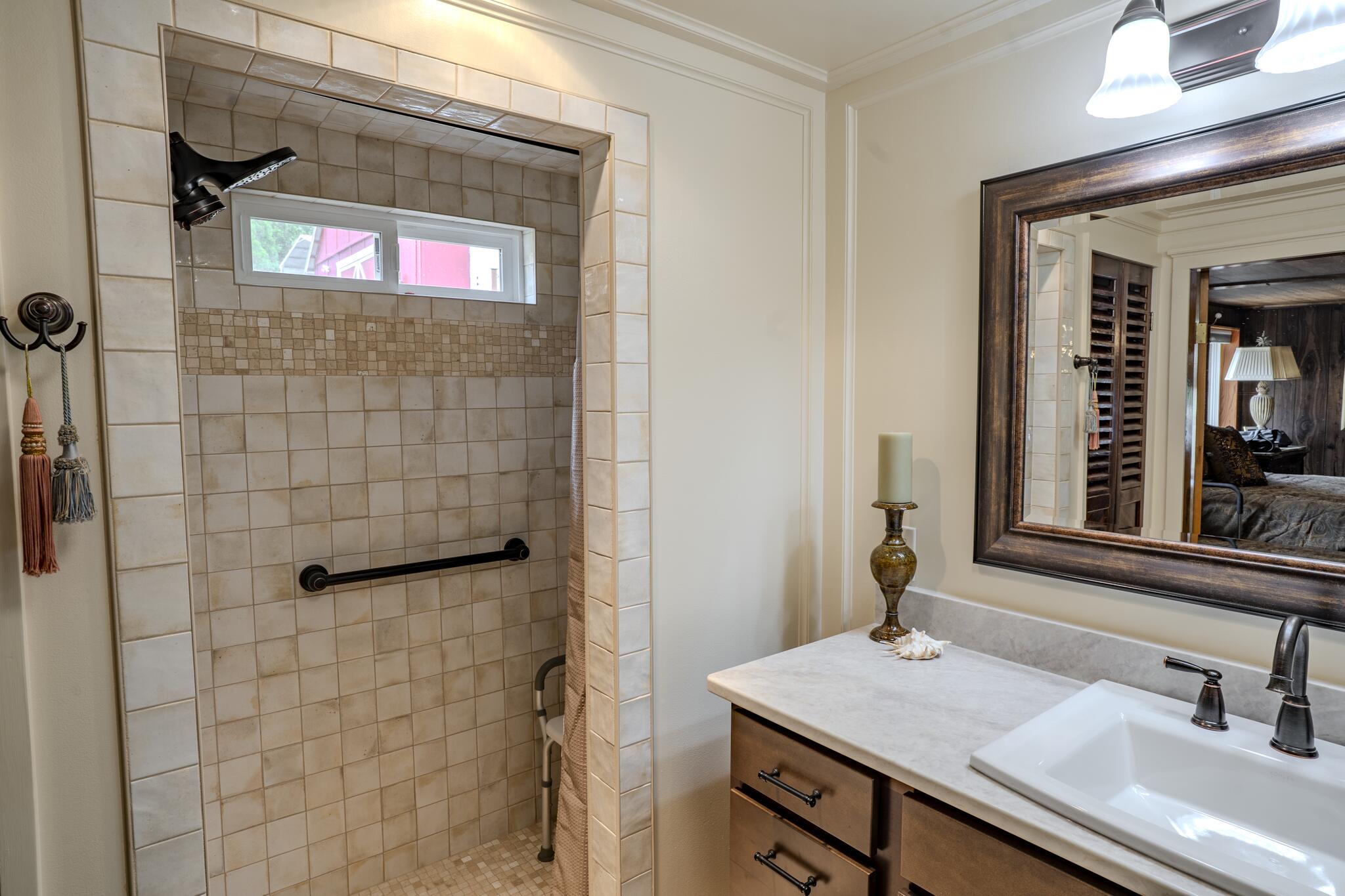 1969 Colestin Road Ashland, OR 97520 - Photo 43 of 72 a bathroom with a granite countertop sink a mirror and shower