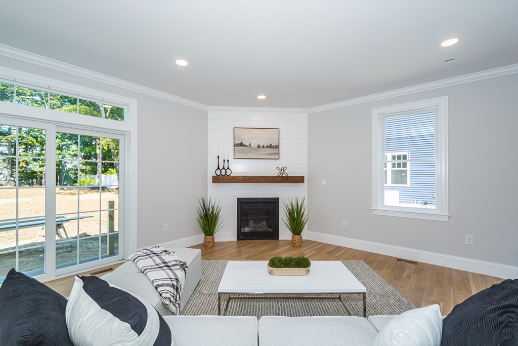 293 Bacon Street, Unit A Natick, MA 01760 - Photo 13 of 35 a living room with furniture and a fireplace