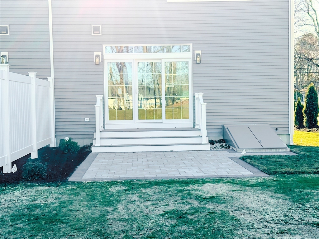 293 Bacon Street, Unit A Natick, MA 01760 - Photo 29 of 35 a view of backyard with a garden and plants