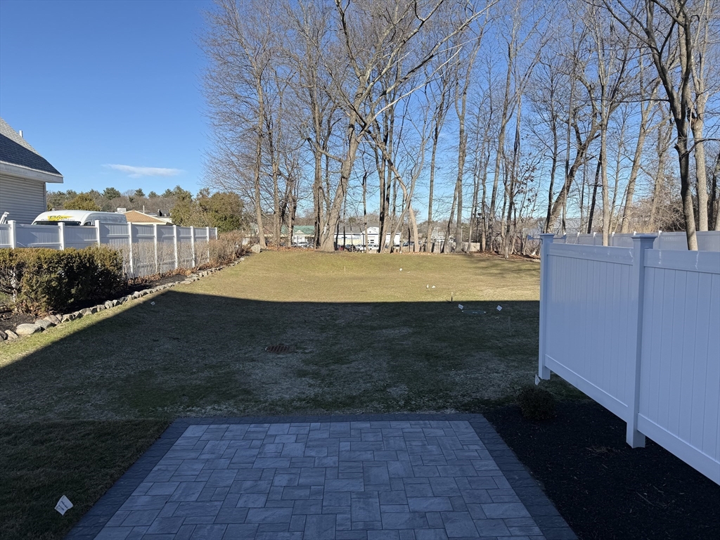 293 Bacon Street, Unit A Natick, MA 01760 - Photo 31 of 35 a view of a yard with an trees
