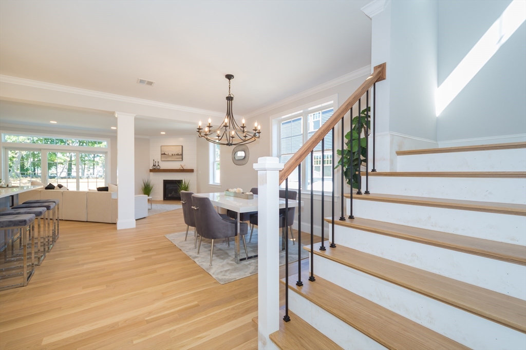 293 Bacon Street, Unit A Natick, MA 01760 - Photo 5 of 35 a view of a dining room with furniture chandelier and wooden floor