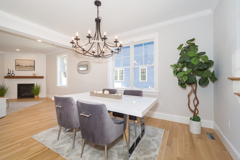 293 Bacon Street, Unit A Natick, MA 01760 - Photo 6 of 35 a view of a dining room with furniture a chandelier and wooden floor