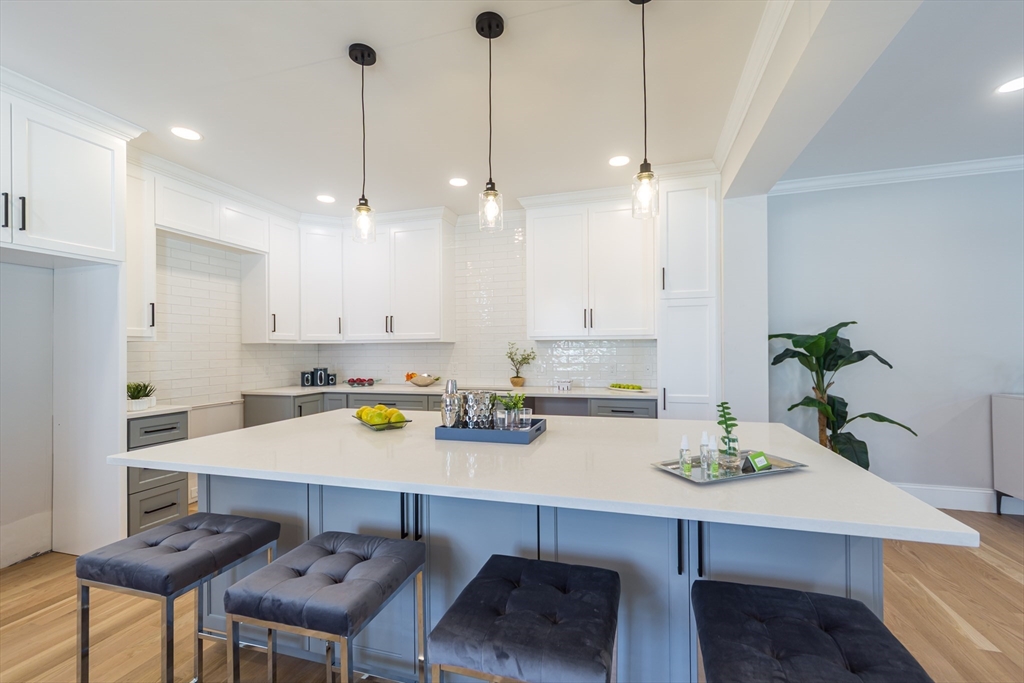 293 Bacon Street, Unit A Natick, MA 01760 - Photo 8 of 35 a kitchen with a table and chairs in it