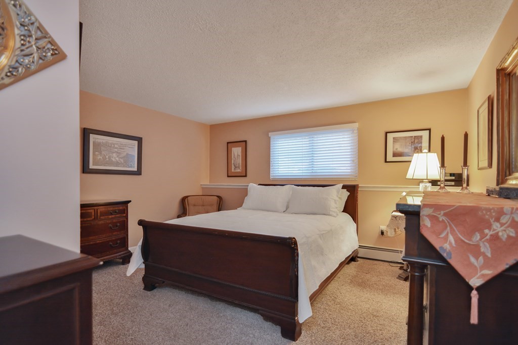 175 Willard Street, Unit 8 Lowell, MA 01850 - Photo 12 of 24 a bedroom with a bed and a dresser