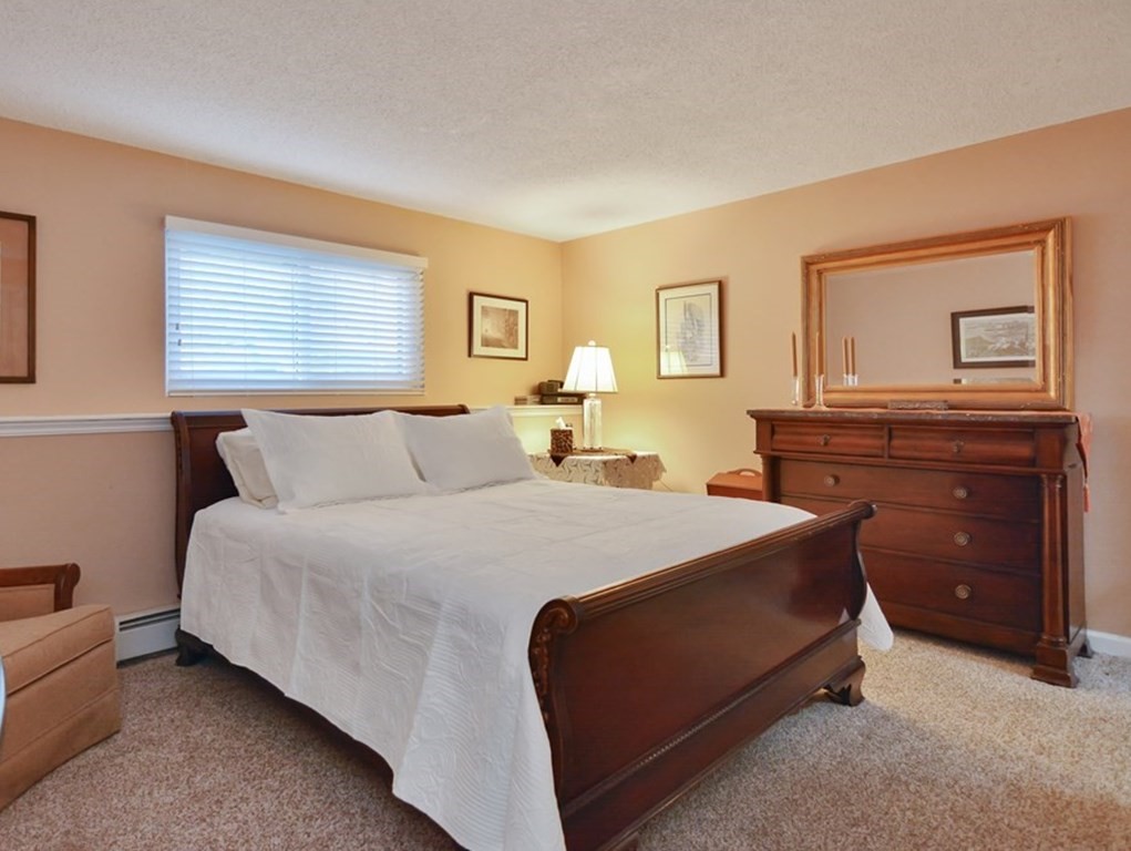 175 Willard Street, Unit 8 Lowell, MA 01850 - Photo 13 of 24 a bed room with a bed and a dresser