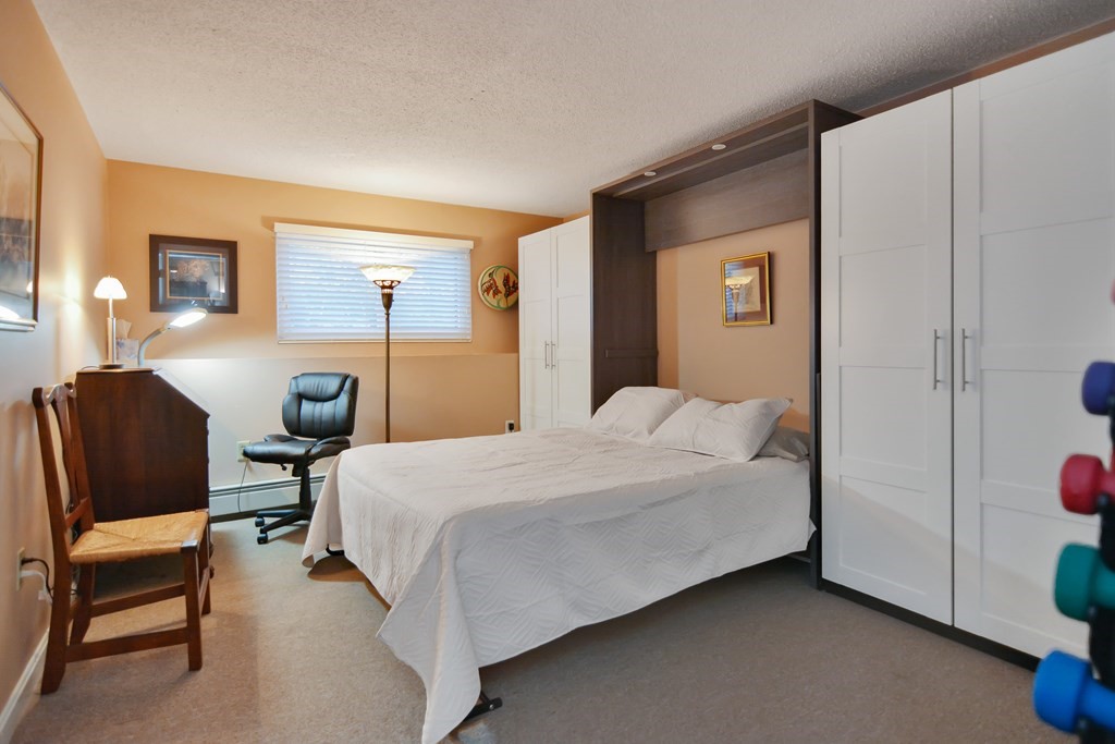 175 Willard Street, Unit 8 Lowell, MA 01850 - Photo 15 of 24 a bedroom with a bed chair and a closet