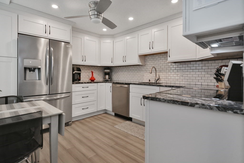 175 Willard Street, Unit 8 Lowell, MA 01850 - Photo 3 of 24 a kitchen with stainless steel appliances a refrigerator stove and sink