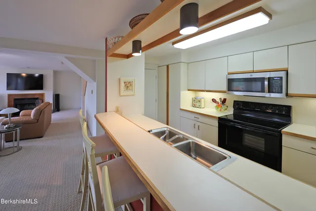 a kitchen that has a sink and a stove top oven