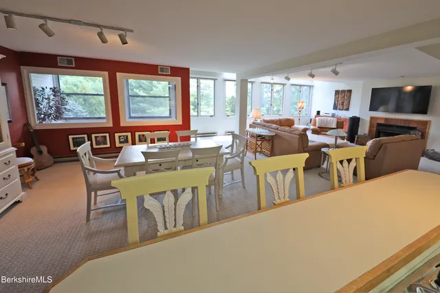a living room with lots of furniture and a large window