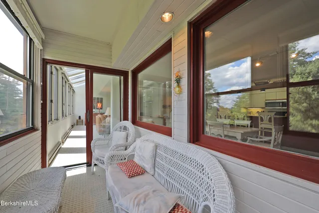 a bedroom with furniture and a large window