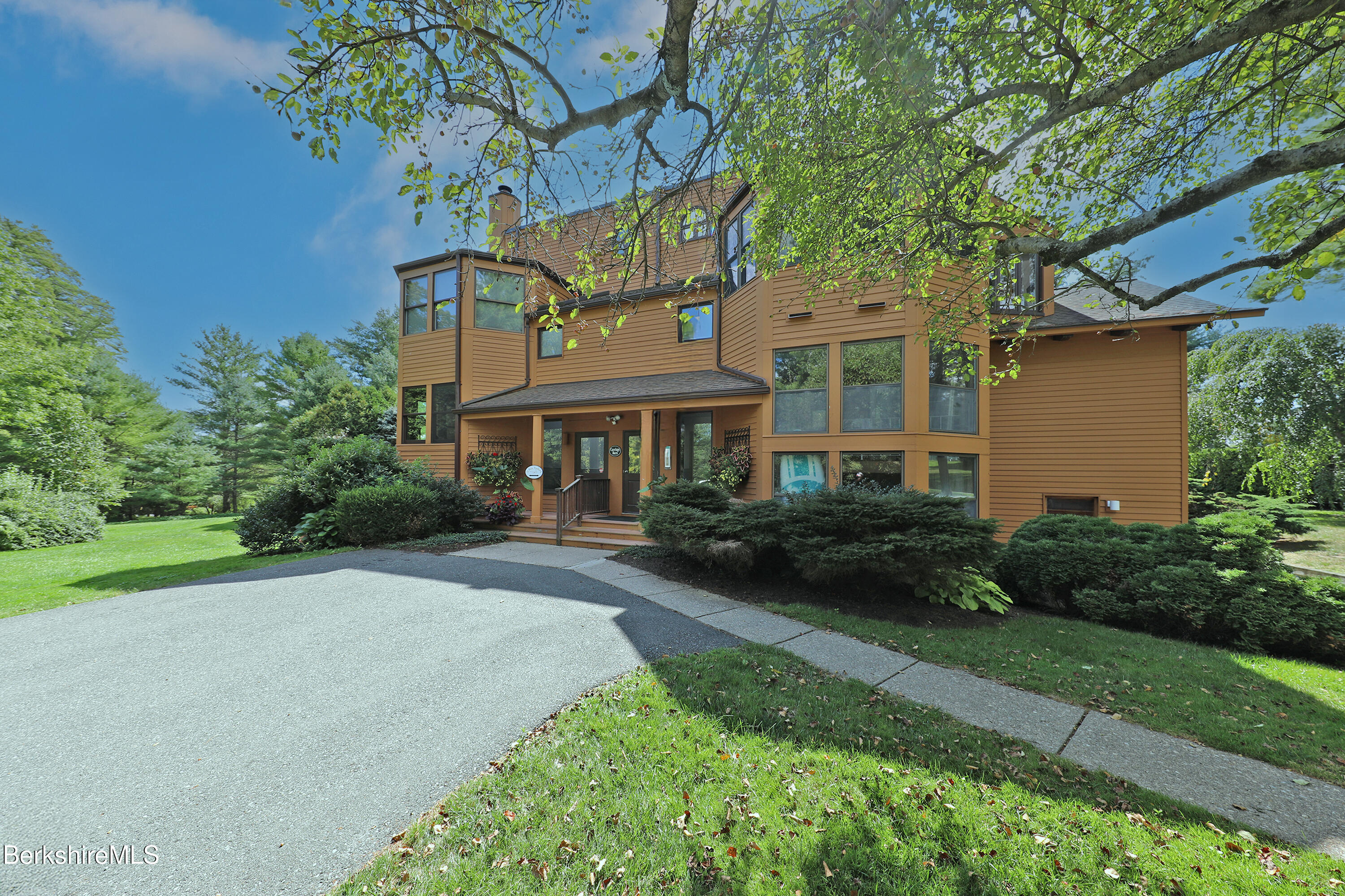 19 Hawthorne Road, Unit CARRIAGE BARN E2 Stockbridge, MA 01262 - Photo 2 of 47 a front view of a house with garden