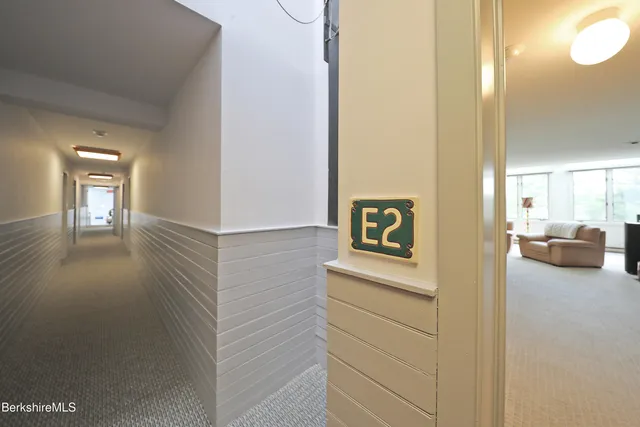 a view of a hallway with cabinet