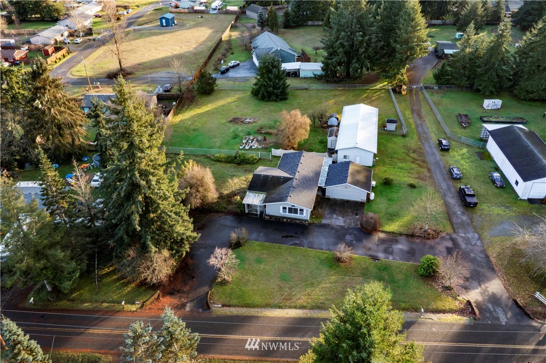 6023 188th Avenue Southwest Rochester, WA 98579 - Photo 3 of 30 an aerial view of a house with swimming pool patio and lake view