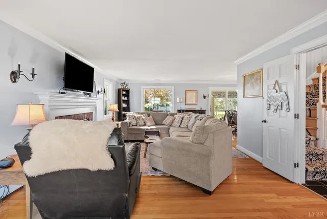 a kitchen with stainless steel appliances granite countertop a refrigerator a sink dishwasher a stove with wooden cabinets and floor