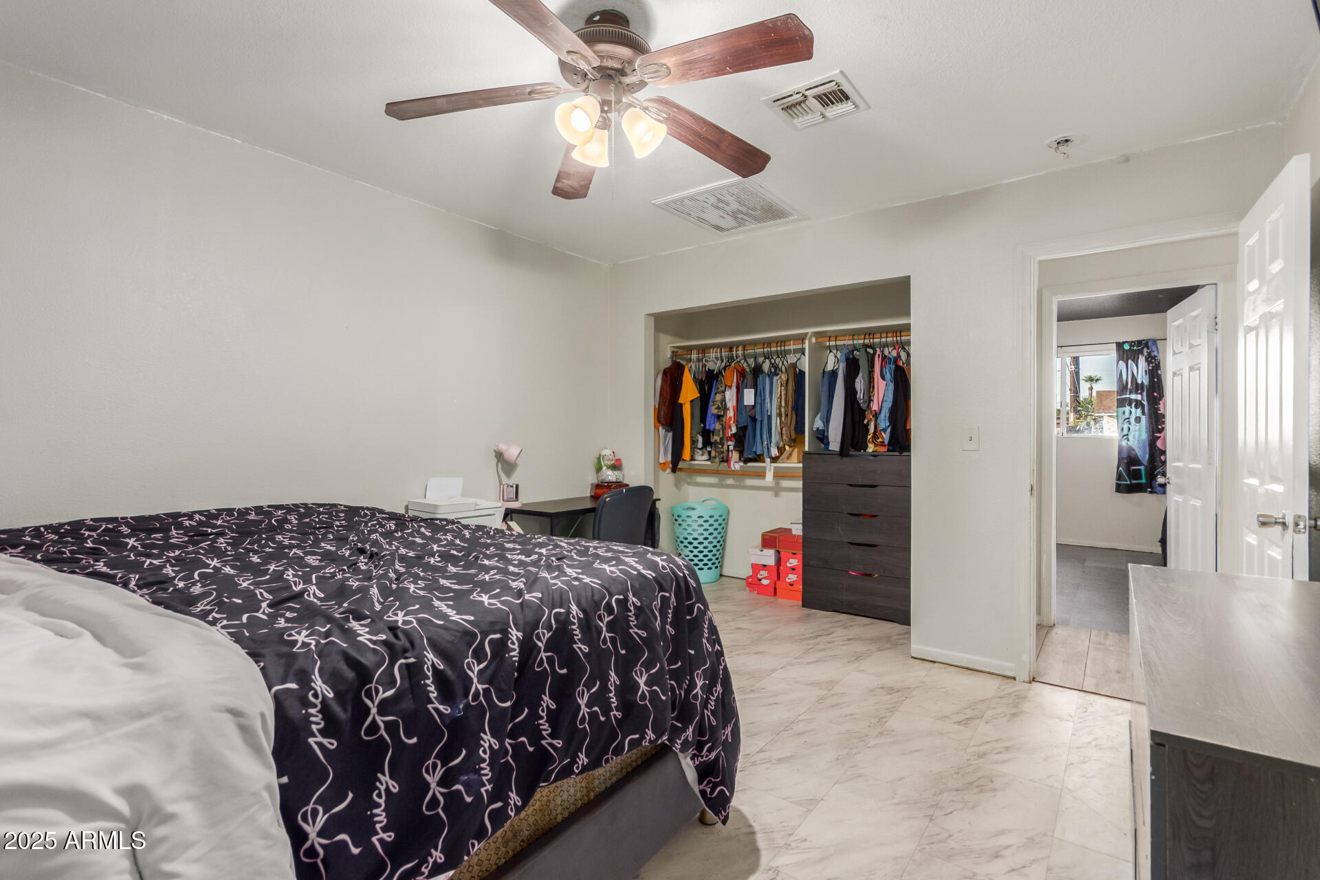 4727 West Osborn Road Phoenix, AZ 85031 - Photo 11 of 22 a bedroom with bed and a chandelier