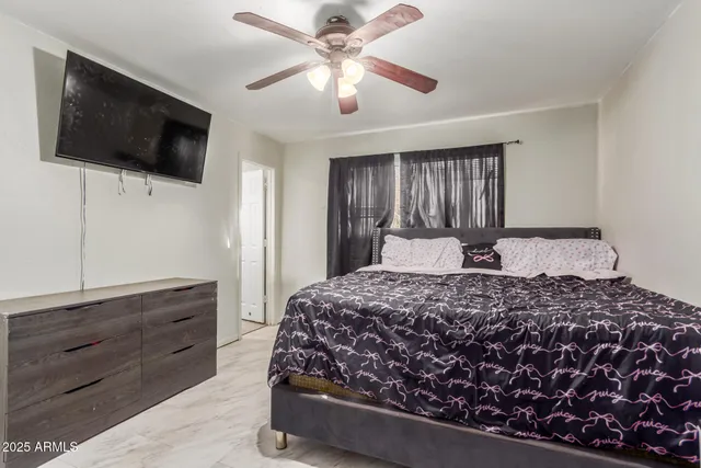 a bedroom with a bed and a flat screen tv