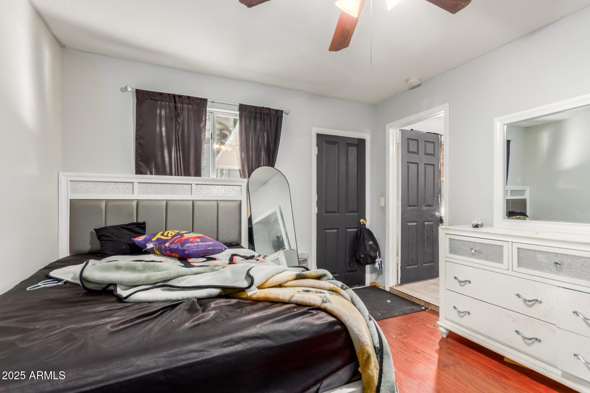 4727 West Osborn Road Phoenix, AZ 85031 - Photo 14 of 22 a bedroom with a bed and window